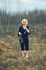 a man in ragged clothes with a Halloween lantern . pumpkin Jack
