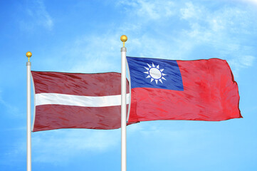 Latvia and Taiwan two flags on flagpoles and blue sky