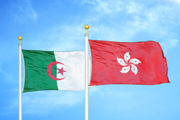 Algeria and Hong Kong two flags on flagpoles and blue sky