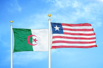 Algeria and Liberia two flags on flagpoles and blue sky