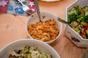 salads in dishes on the kitchen table