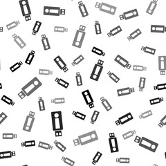 Black USB flash drive icon isolated seamless pattern on white background. Vector.