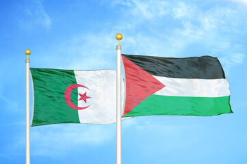 Algeria and Palestine two flags on flagpoles and blue sky