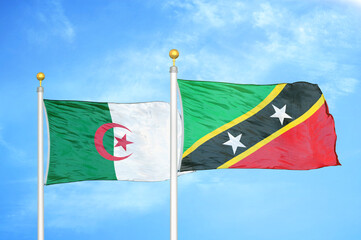 Algeria and Saint Kitts and Nevis two flags on flagpoles and blue sky
