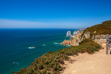 A wide angle image of the famous cabo da roca (Cape Roca) the promontory that marks the westernmost point in continental Europe. Photo features steep cliffs, granite boulders, carpobrotus edulis plant