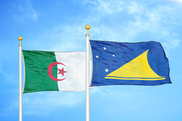 Algeria and Tokelau two flags on flagpoles and blue sky