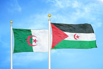 Algeria and Western Sahara two flags on flagpoles and blue sky