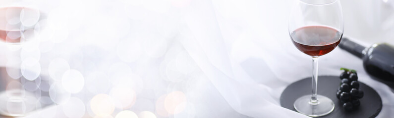 Glass with grape red semi-dry wine. Valentine's day concept background. Gift for the holiday. Sweet sparkling wine.