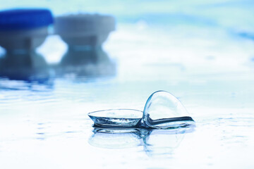 Tools for vision correction. Glasses and lenses with diopters on the background of splashes and...