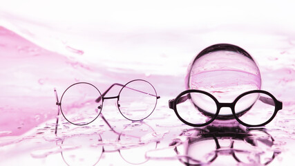 Tools for vision correction. Glasses and lenses with diopters on the background of splashes and...