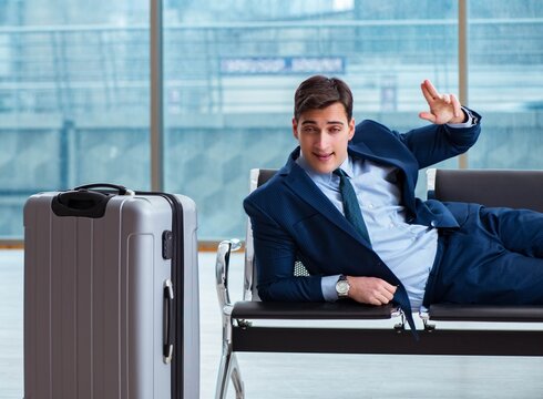 Businessman waiting at the airport for his plane in business cla
