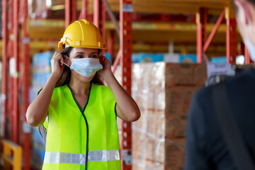 Young Attractive Hispanic Latin ethnic women wearing protective face mask during working in warehouse, new normal after Covid-19 pandemic crisis. Logistic industry concept.