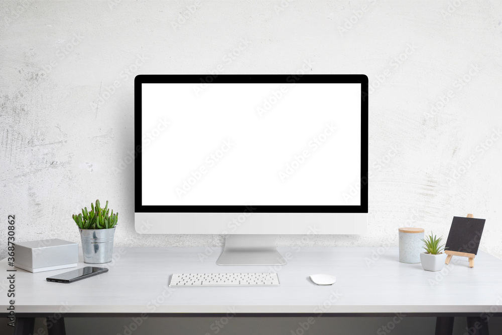 Poster computer display mockup on work desk. white work desk with plants, phone, box, keyboard and mouse. w