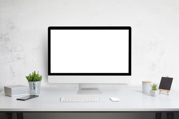 Computer display mockup on work desk. White work desk with plants, phone, box, keyboard and mouse. Web site design promotion template