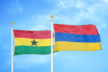 Ghana and Armenia two flags on flagpoles and blue sky