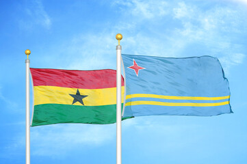 Ghana and Aruba two flags on flagpoles and blue sky