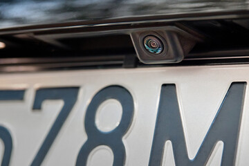 Luxury rear car rear view camera close up for parking assistance. Concept of safety car driving while parking process. Assist device equipment in modern cars