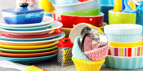 Colorful dishes and utensils. Ceramic kitchenware on a wooden background. Selective focus