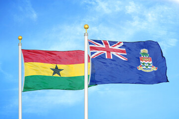 Ghana and Cayman Islands two flags on flagpoles and blue sky