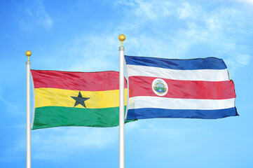 Ghana and Costa Rica two flags on flagpoles and blue sky