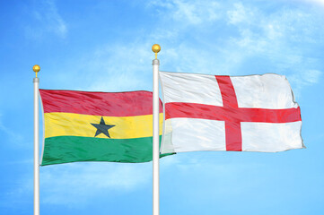 Ghana and England two flags on flagpoles and blue sky