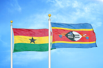Ghana and Eswatini Swaziland two flags on flagpoles and blue sky