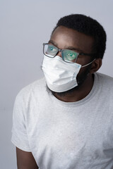 Young African man in medical face protection mask