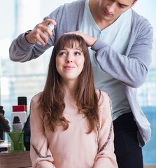 Fototapeta premium Man stylist working with woman in beauty salon