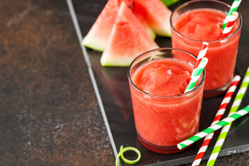 Glass of watermelon smoothie on a dark table. Selective focus. Copy space