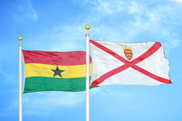 Ghana and Jersey two flags on flagpoles and blue sky