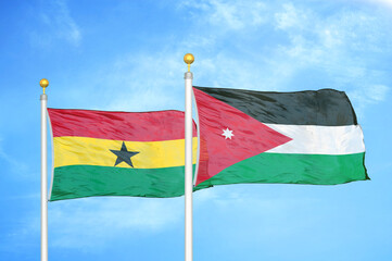 Ghana and Jordan two flags on flagpoles and blue sky