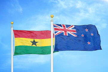 Ghana and New Zealand two flags on flagpoles and blue sky