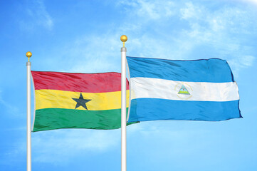 Ghana and Nicaragua two flags on flagpoles and blue sky