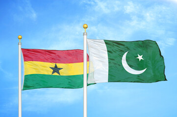 Ghana and Pakistan two flags on flagpoles and blue sky