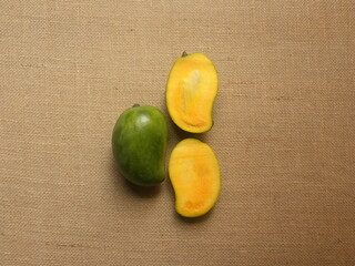 Whole and cut green and yellow color ripe fresh Neelam mangoes