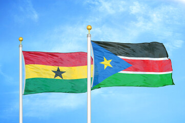 Ghana and South Sudan two flags on flagpoles and blue sky