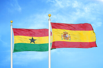 Ghana and Spain two flags on flagpoles and blue sky
