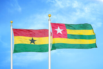 Ghana and Togo two flags on flagpoles and blue sky