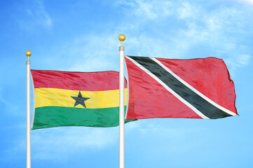 Ghana and Trinidad and Tobago two flags on flagpoles and blue sky