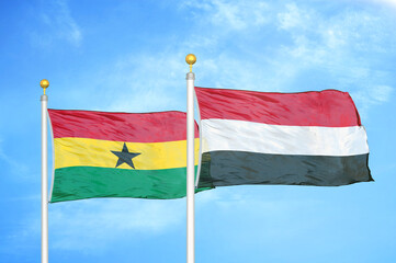 Ghana and Yemen two flags on flagpoles and blue sky