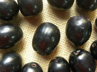Black color raw whole fresh Java plum fruit or Syzygium cumini