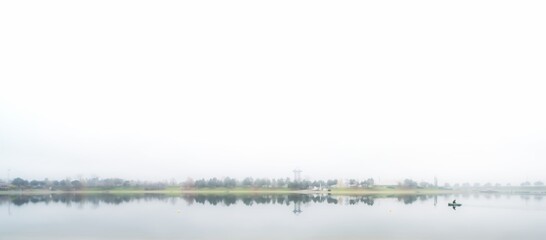 landscape with lake in the fog