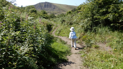 Naklejka na ściany i meble child walking on a mountain path