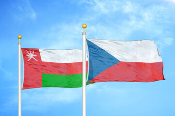 Fototapeta na wymiar Oman and Czech Republic two flags on flagpoles and blue sky