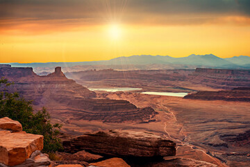 A view of Canyonlands backcountry at sunrise from Dead Horse Point State Park in Moab, Utah USA.