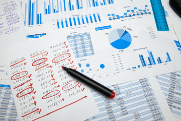 business office desk closeup - financial reports, analysis and accounting, set of documents, tables and graphs, various items for bookkeeping, calculator