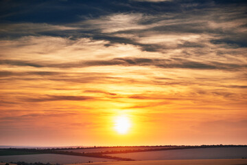 Fototapeta na wymiar wheat field in a beautiful sunset, sunlight and clouds