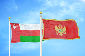 Oman and Montenegro two flags on flagpoles and blue sky