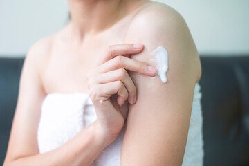 Asia woman applying arm cream,lotion , Hygiene skin body care concept.