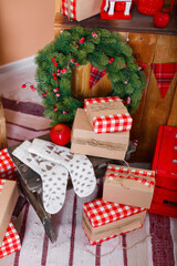 Christmas presents/gifts under fir-tree. Vintage New Year decorations. Red gift boxes and lantern under fir-tree. Christmas mood. Celebrating of New Year